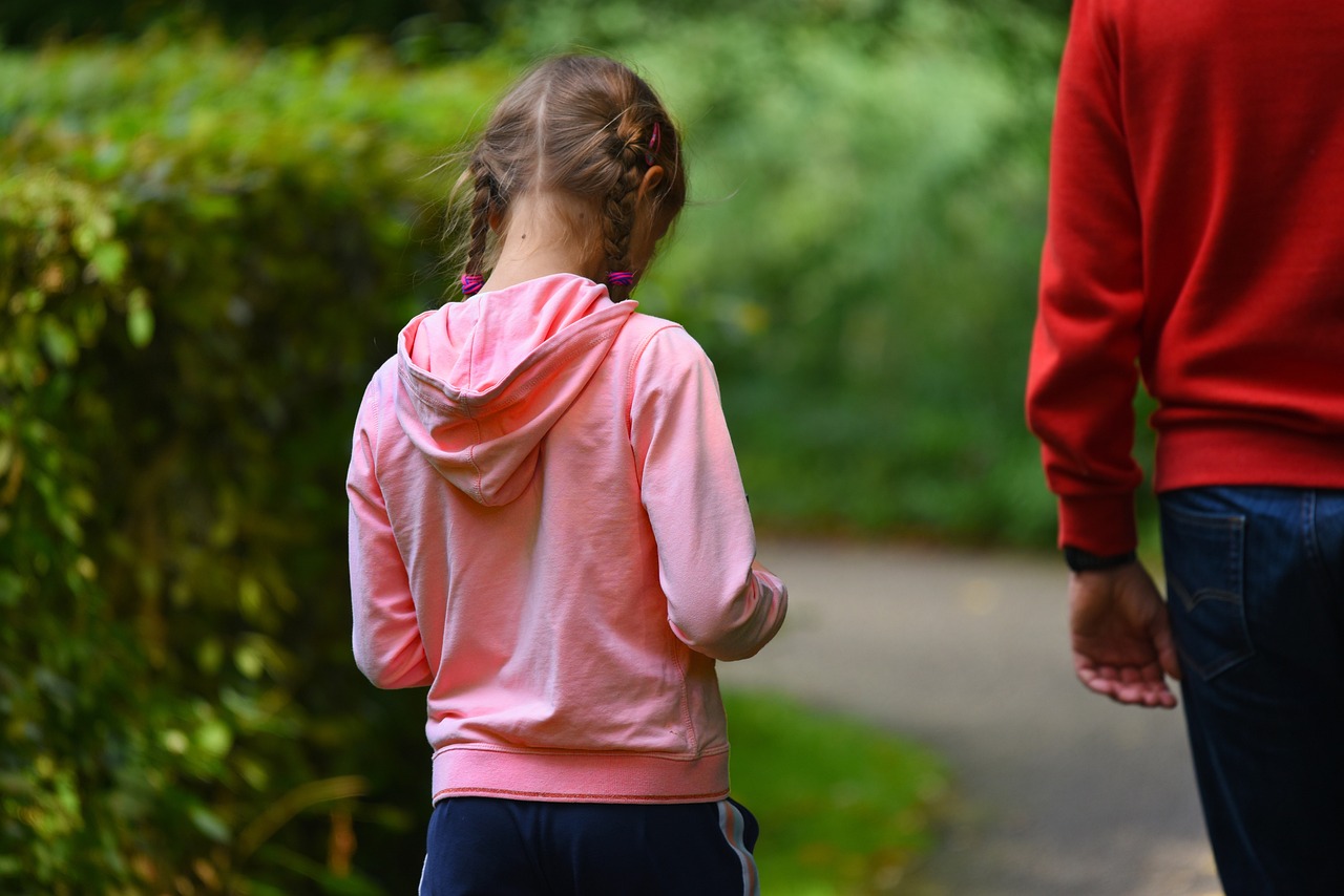 A father and daughter walking together